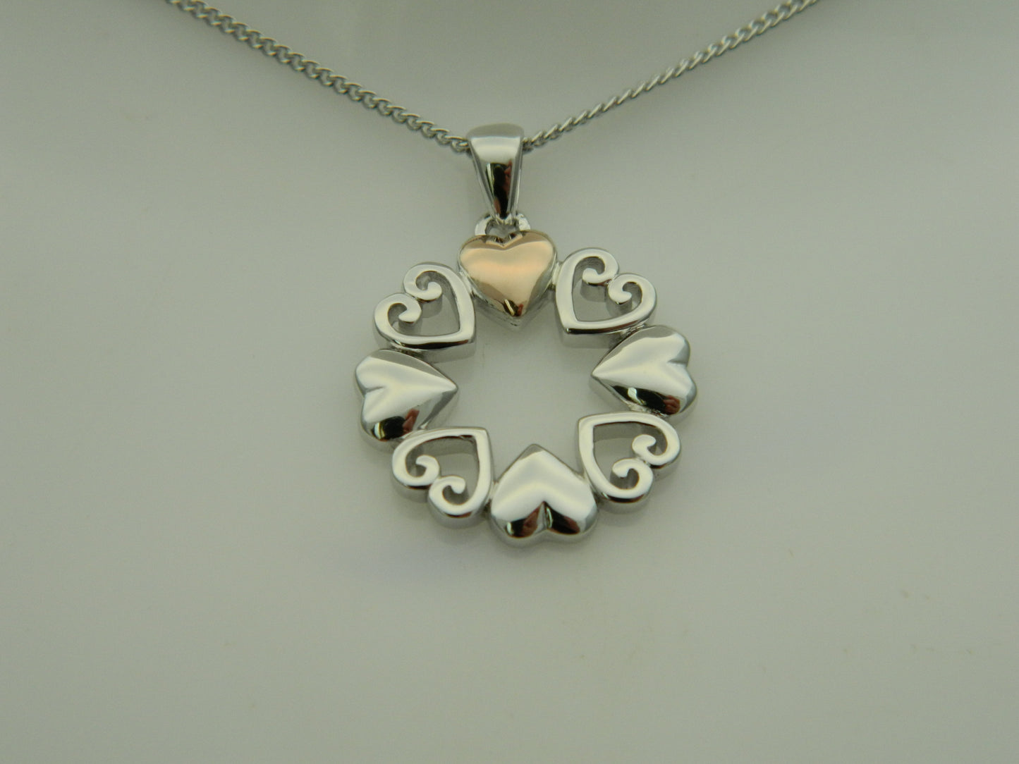 Clogau Sterling Silver & 9ct Rose Gold Hearts Embrace Circular Pendant