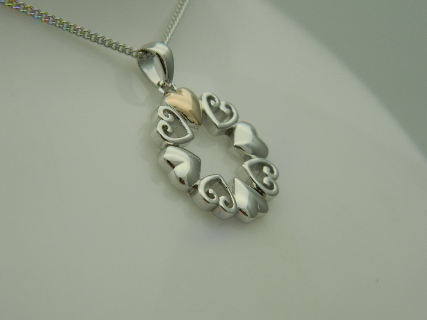 Clogau Sterling Silver & 9ct Rose Gold Hearts Embrace Circular Pendant